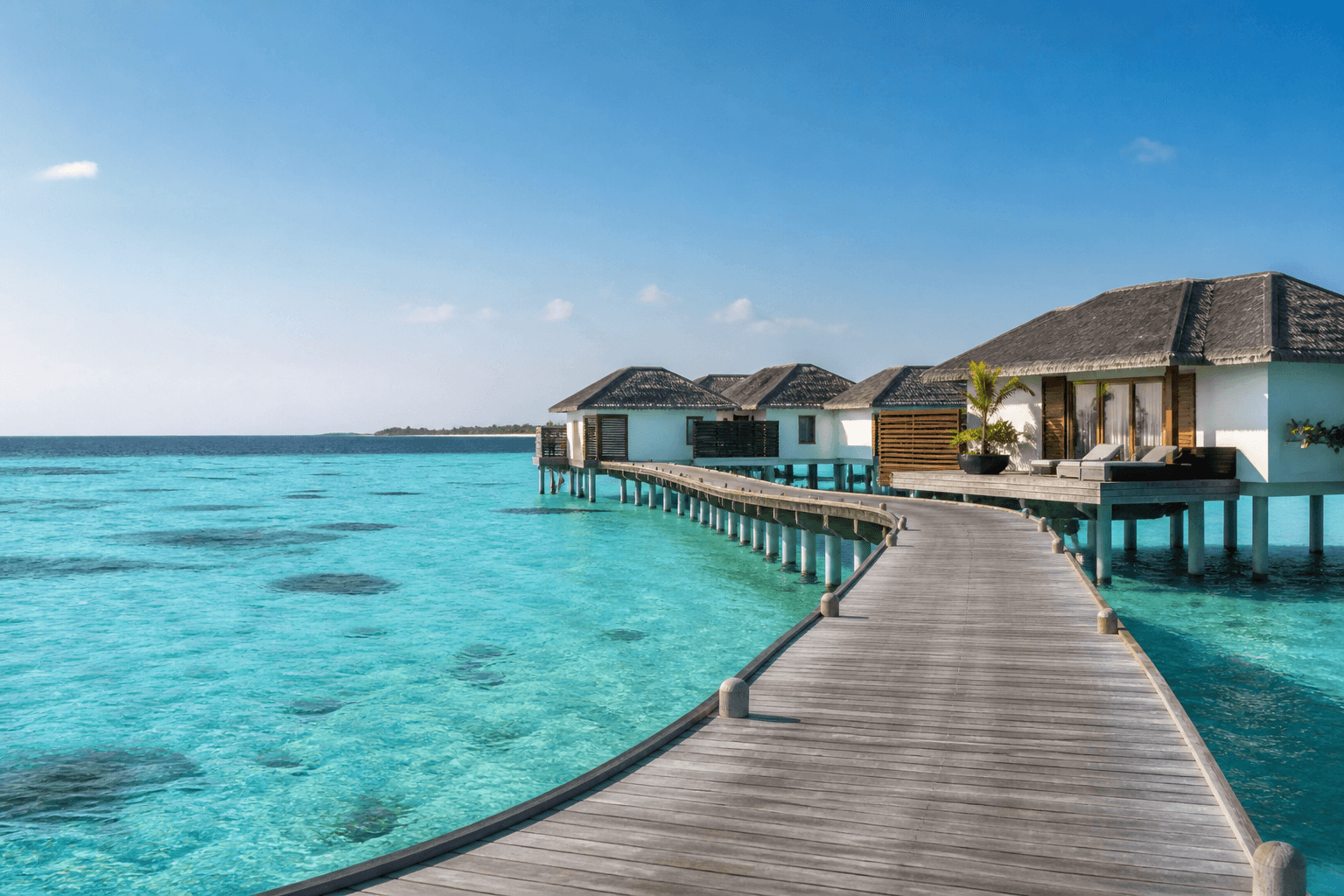 Overwater villas above a turquoise Maldives lagoon
